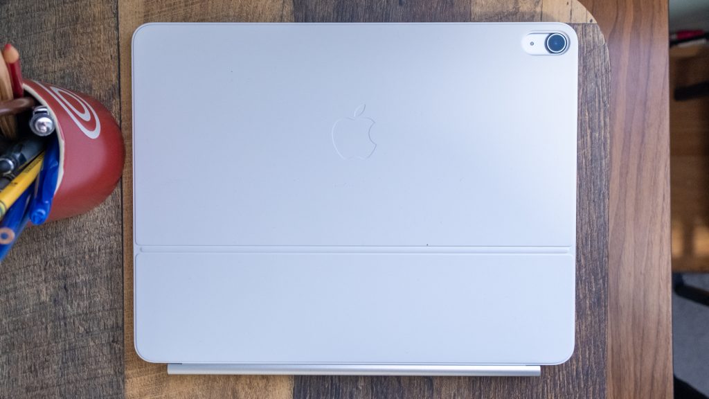 Apple iPad Air (2025) in a Magic Keyboard, folded up on a table.