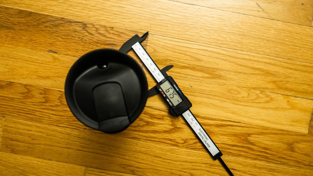A pair of calipers showing the width of the Contigo Byron Tavel mug’s base