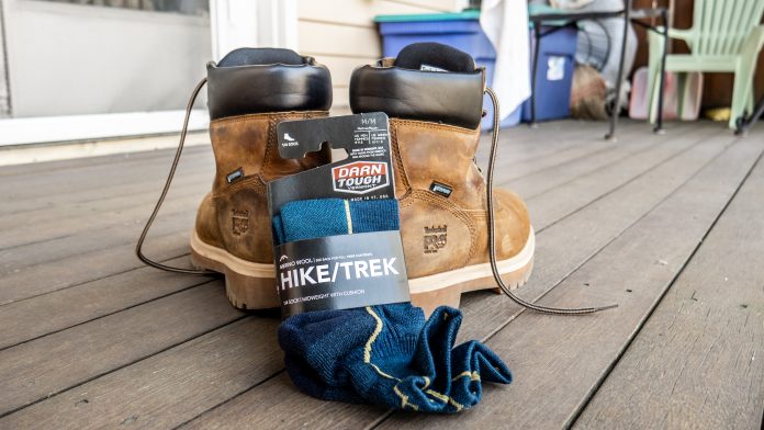 Darn Tough hiking socks next to a pair of work boots