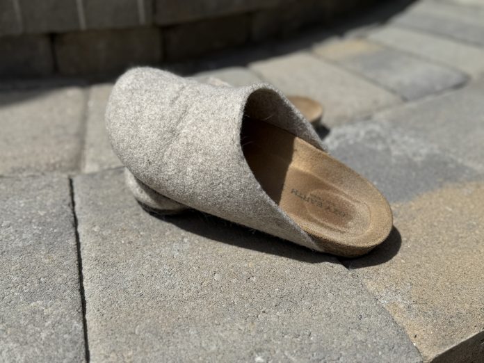 Cozy Earth Lakehouse Clog on paver steps.