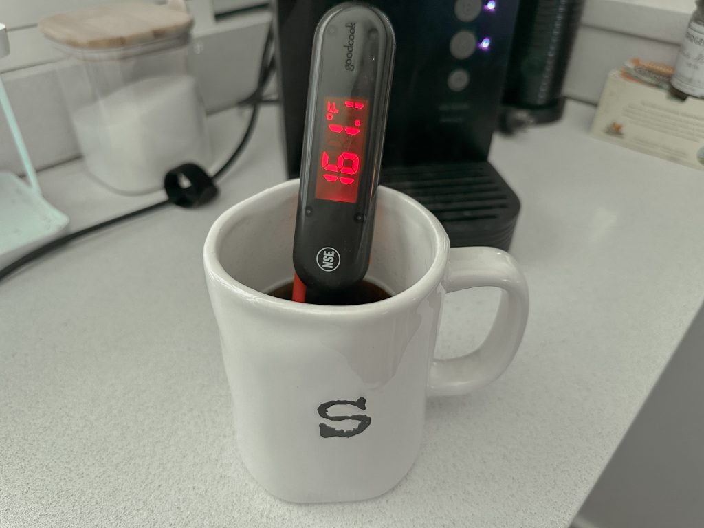 A mug with a thermometer in it reading 161.1ºF