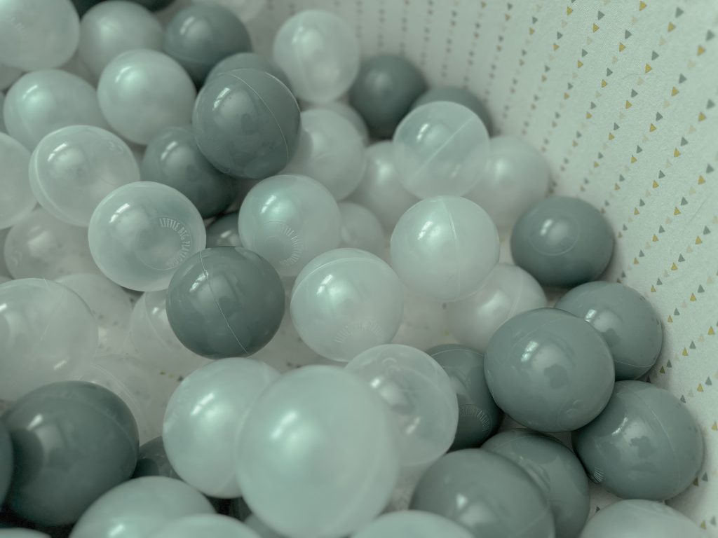 various plastic balls in a memory foam pit