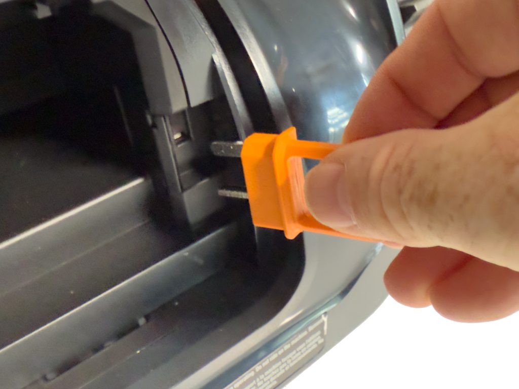 The orange key that gets plugged in to the right of the battery serves as a safety and anti-theft device. Without the key, the mower will not function.
