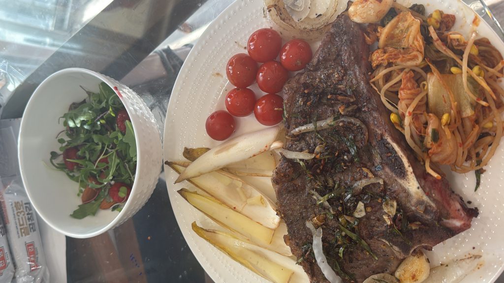 dry-aged-t-bone-steak-kimchi-soybeans-endives-cherry-tomatoes-made-by-smithey-double-burner-griddle