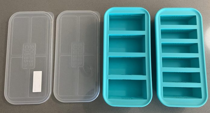 aqua Souper Cube trays in half-cup and 1-cup sizes set next to their clear lids