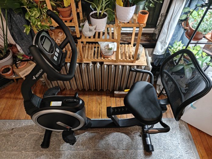Merach S19 recumbent exercise bike in living room