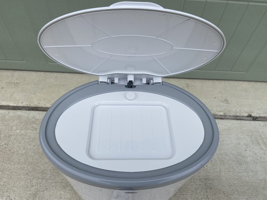 Open lid on the Dekor diaper pail showing the trap door